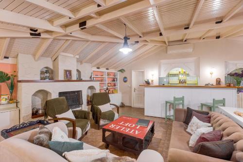 a living room with couches and a fireplace at Gurel Garden House in Kucukkuyu