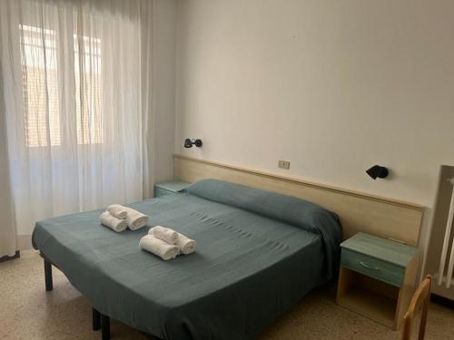 a bedroom with two towels on a bed at Ubika Hotel in Porto San Giorgio