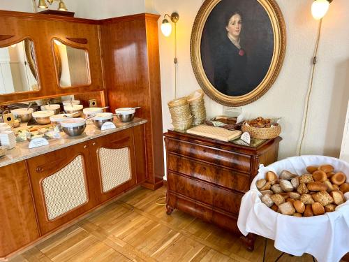 a room with a vanity and a portrait of a woman at Panorama Hotel Lohme in Lohme