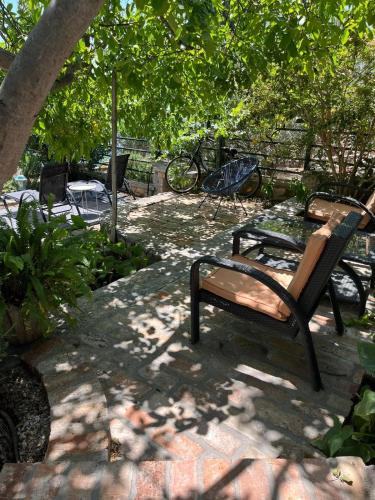 a bench sitting on a patio under a tree at Romantic apartments in Šibenik
