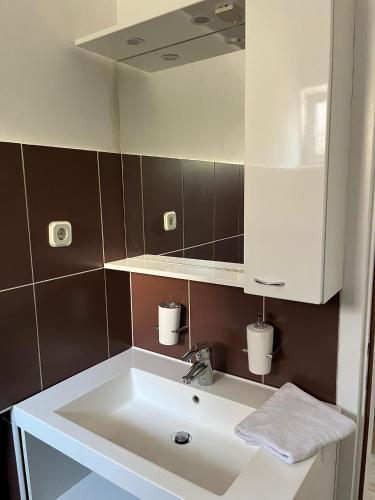 a bathroom with a white sink and a mirror at Romantic apartments in Šibenik