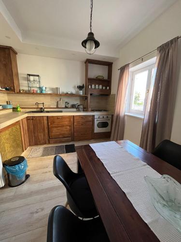 a kitchen with a wooden table and a dining room at Romantic apartments in Šibenik