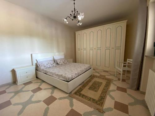a bedroom with a bed and a chandelier at La Campanella in Manduria