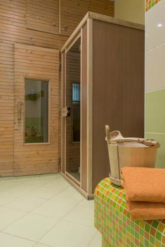a bathroom with a shower and a sink on a table at Penzion U Hraběnky in Petrovice