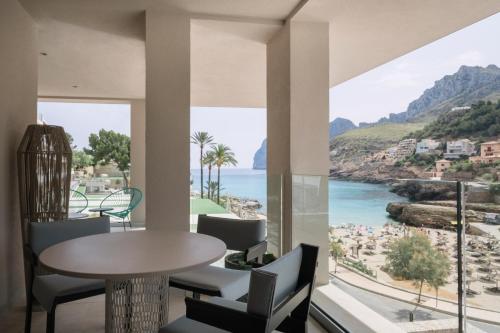 a room with a view of the beach and ocean at El Vicenç de la Mar - Adults Only - Over 12 in Pollença