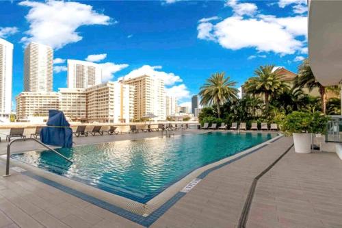 a swimming pool with a city skyline in the background at BeachWalk 1B 1B Incredible View apartment 14 A in Hallandale Beach