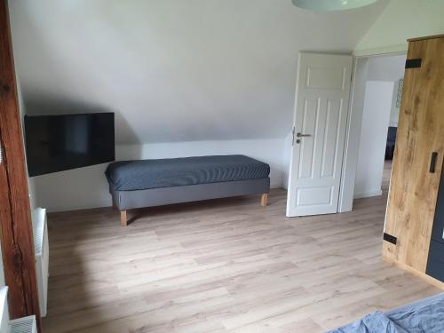 a room with a bench and a flat screen tv at stay at Randolphs in Kassel
