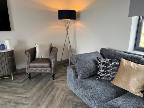 a living room with a couch and a chair at Machrie View in Port Ellen
