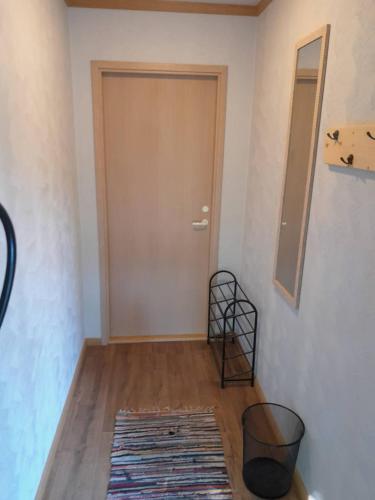 a hallway with a door and a rug on the floor at Annimatsi Camping in Otepää