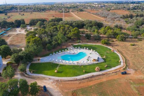 an aerial view of a large swimming pool on a field at Tenuta Ferraro Gallipoli in Gallipoli