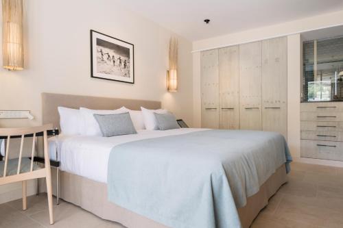 a bedroom with a large bed and a desk at El Vicenç de la Mar - Adults Only - Over 12 in Pollença