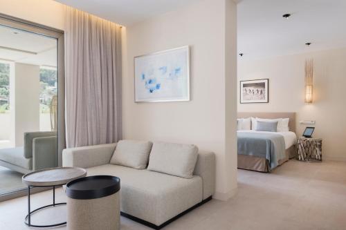 a living room with a couch and a bed at El Vicenç de la Mar - Adults Only - Over 12 in Pollença