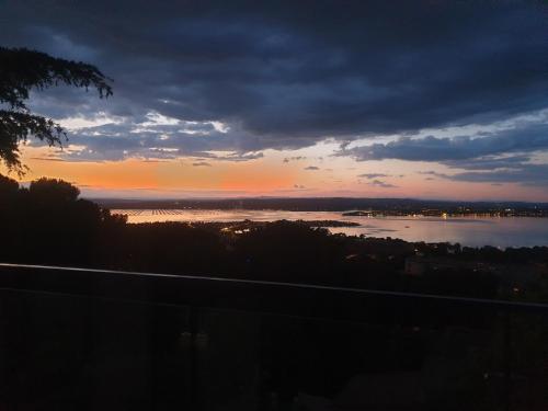 un coucher de soleil sur une étendue d'eau avec le ciel dans l'établissement à la cime du mont Saint Clair, à Sète