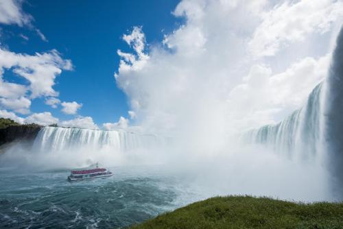 a boat in the water in front of a waterfall at Holiday Inn Express Niagara-On-The-Lake by IHG in Niagara-on-the-Lake