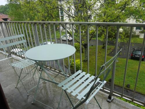 d'une table et de deux chaises sur un balcon. dans l'établissement Appartement T2 avec place de parking, à Bayonne