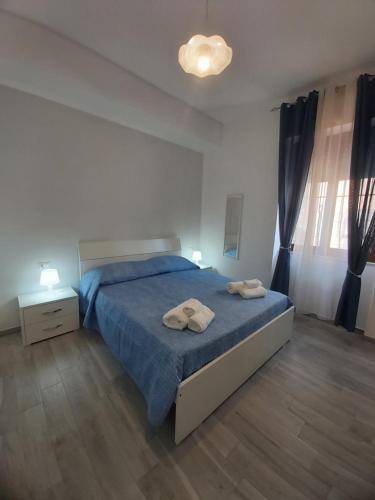 a bedroom with a bed with two towels on it at B&B RAFFAELA in Marina di Camerota