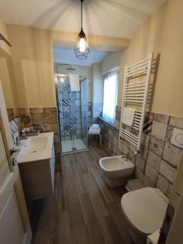 a bathroom with a sink and a toilet and a tub at Bricco - Bed&Breakfast in Murisengo