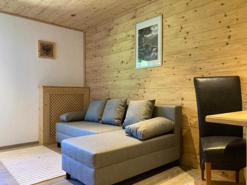 a living room with a couch and a table at Öfnerhof in Leutasch