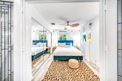 a bedroom with a king sized bed and a mirror at Chique Pool and Tiki Resort in Pompano Beach