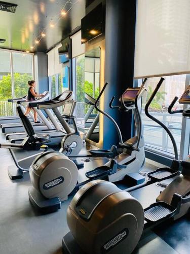 a woman sitting on a treadmill in a gym at Miami Beach Glam, Ocean Views & Elegance -28B in Hallandale Beach