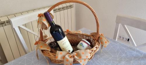 a basket with a bottle of wine and an egg at Guest House Tamara in Žabljak