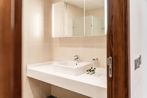 a bathroom with a sink and a mirror at Gaya Residences in Shahdag