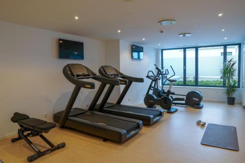 a gym with several exercise bikes in a room at Holiday Inn Munich - Leuchtenbergring by IHG in Munich