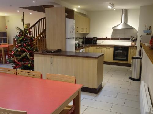 a kitchen with a christmas tree in the middle at ancien moulin à eau entièrement rénové in Prat