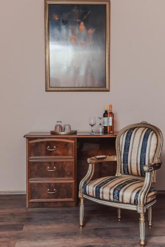 a desk with a chair next to a dresser at Villa 1880 in Sremski Karlovci