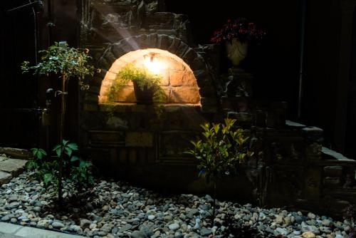 a stone oven in a garden at night at Villa 1880 in Sremski Karlovci