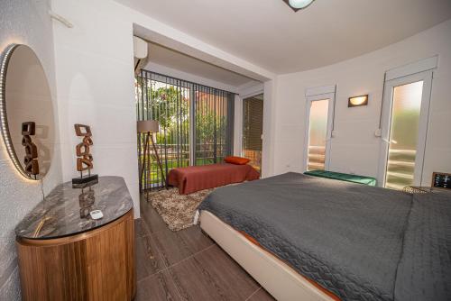 a bedroom with a bed and a mirror and a balcony at Lux Villa Princess in Bar