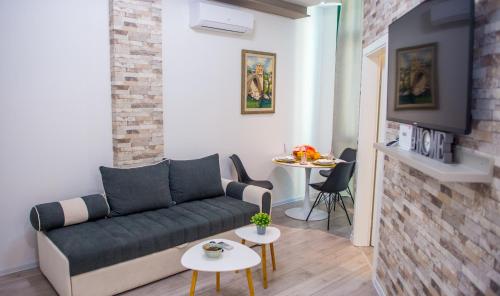 a living room with a couch and two tables at Apartment Neretva Magic Dream in Mostar