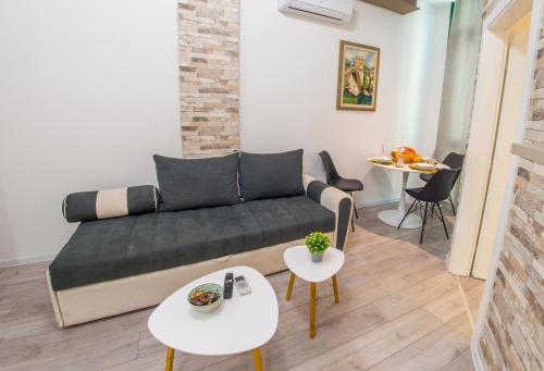 a living room with a couch and two tables at Apartment Neretva Magic Dream in Mostar