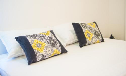 two pillows sitting on top of a bed at Apartment Neretva Magic Dream in Mostar
