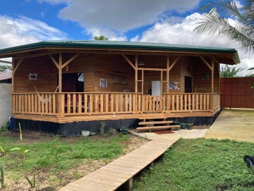 a log cabin with a porch and a deck at Bungalows Baobab in San Isidro