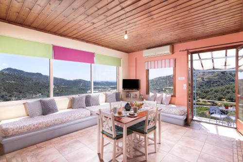 a living room with a couch and a table at Sarakinas Residences in Myrtos