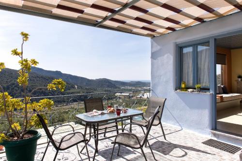 a table and chairs on a patio with a view at Sarakinas Residences in Myrtos