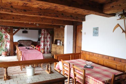 a dining room with two tables and a table and chairs at GITE DES FUVES in Luisans