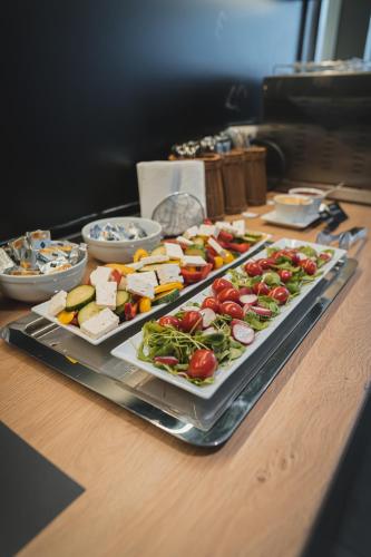 a table with a tray of different types of food at Avenue Pallova 28 in Plzeň