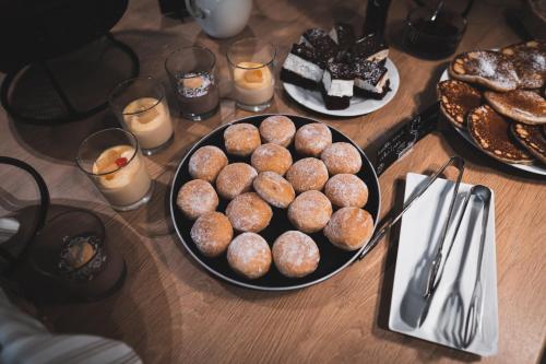 a table with a plate of donuts and candles at Avenue Pallova 28 in Plzeň