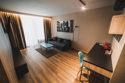 a living room with a couch and a table at Avenue Pallova 28 in Plzeň
