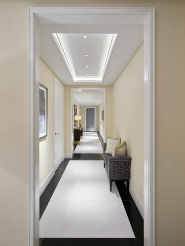 a hallway with chairs and a long corridor at Four Seasons Hotel London at Tower Bridge in London