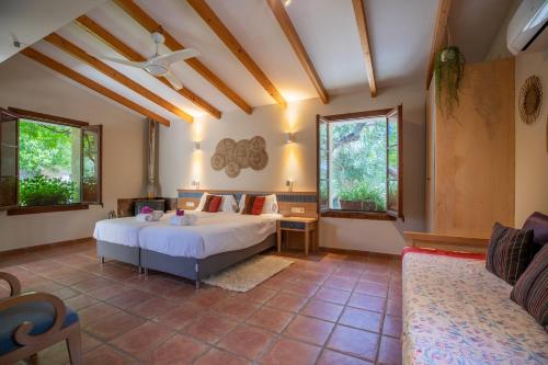 a bedroom with a bed and a couch at Selva - 38903 Mallorca in El Port de la Selva