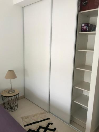 a closet with a glass door in a room at Foix cœur de ville in Foix