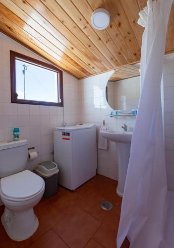 a bathroom with a toilet and a sink at Aurora House in Mosteiros