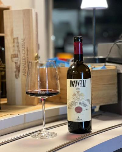 a bottle of wine and a glass on a counter at Camping Solcio in Lesa