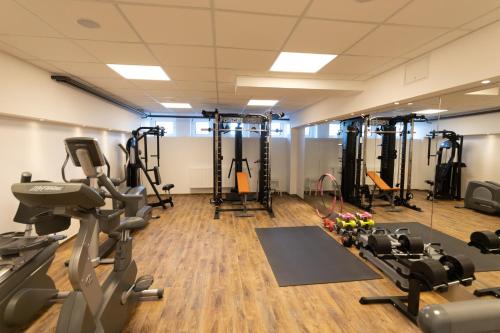 a gym with treadmills ellipticals and exercise bikes at Hotel Wald und See in Heringsdorf
