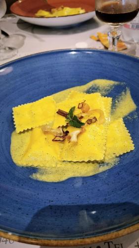 a blue plate of food on a table at Camping Solcio in Lesa