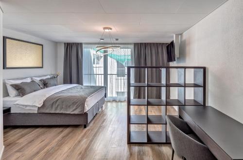a bedroom with a bed and a book shelf at MOOI Apartments Schlieren in Schlieren