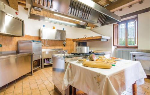 a large kitchen with a table with food on it at Casa Ssilvestro in Borghetto di Fenigli